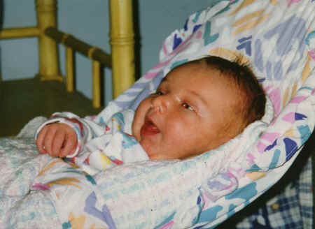 cameron - 3 weeks - in baby chair - trying to stick out tongue.jpg (274577 bytes)