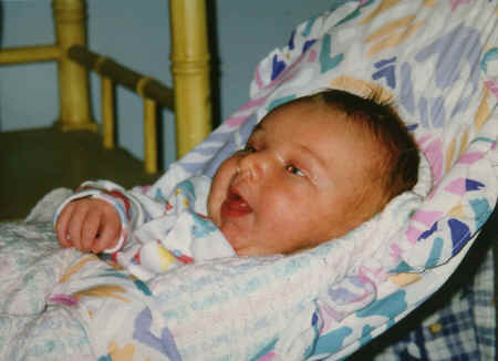 cameron - 3 weeks - in baby chair - trying to stick out tongue - #2.jpg (264998 bytes)