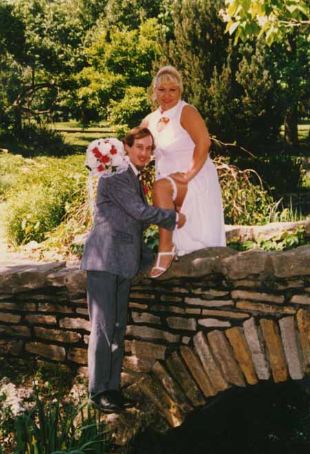 chris - crystal - on bridge removing garter - #2 copy.jpg (47096 bytes)