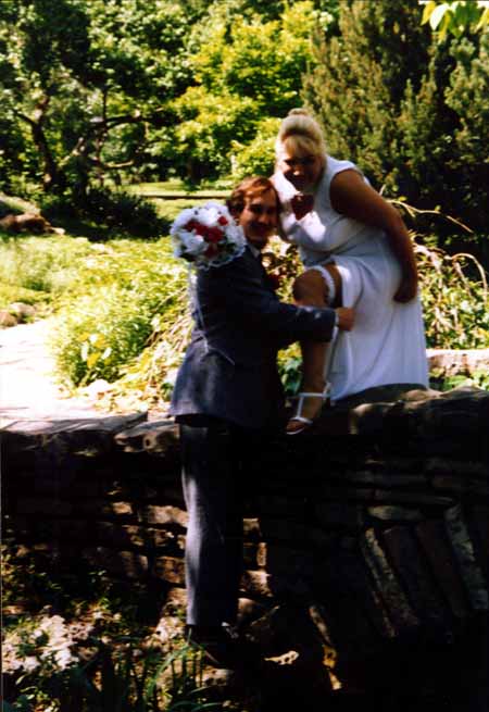 chris - crystal - on bridge removing garter - #3 copy.jpg (43807 bytes)